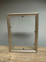 8 x 5.5 in silver frame with glass, simple double rounded profile.